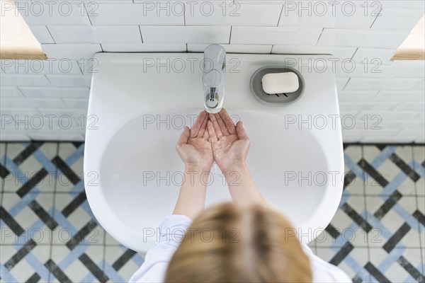 Top view washing her hands sink