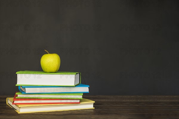 Wooden desk with books apple