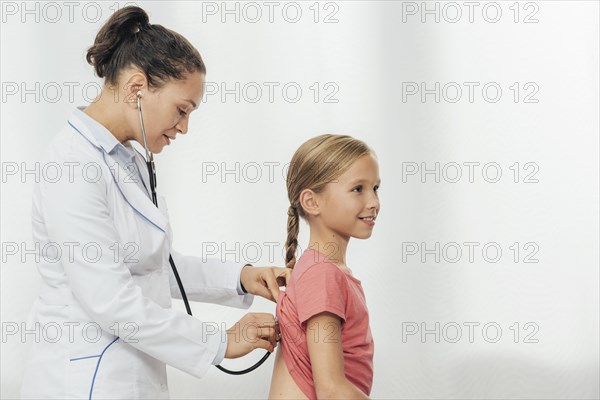 Medium shot doctor checking girl