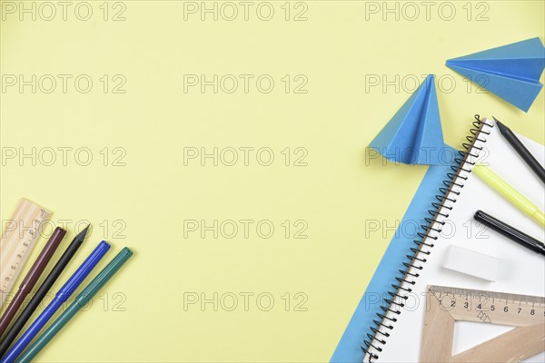 Office stationaries folded paper yellow background