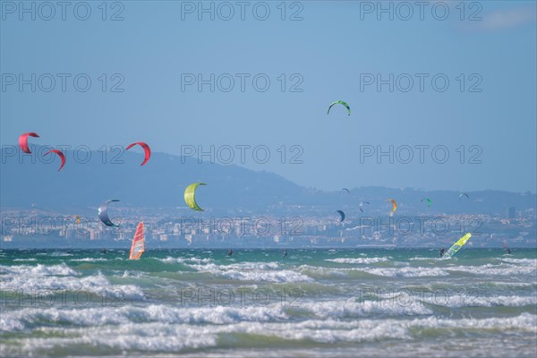 Kiteboarding kitesurfing kiteboarder kitesurfer kites on the Atlantic ocean beach at Fonte da Telha beach