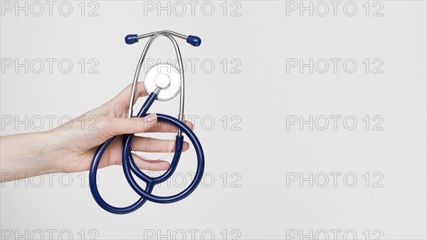 Close up hand holding stethoscope