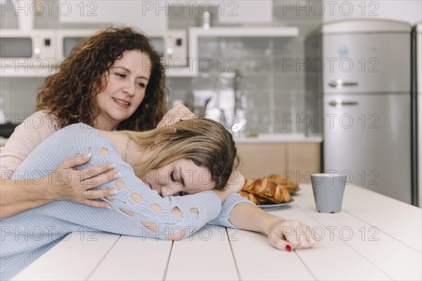 Mom comforting tired daughter