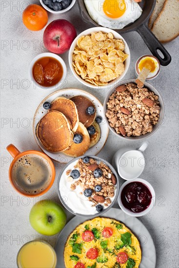 Top view cereal with omelette pancakes breakfast