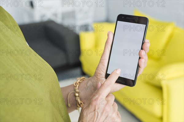 Senior woman s hand touching cellphone screen