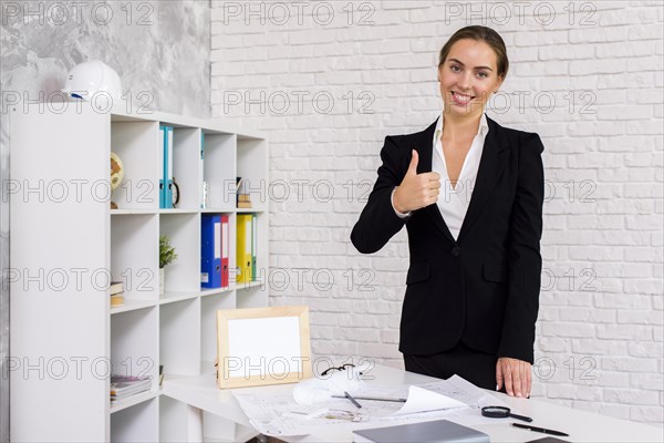 Businesswoman giving thumbs up