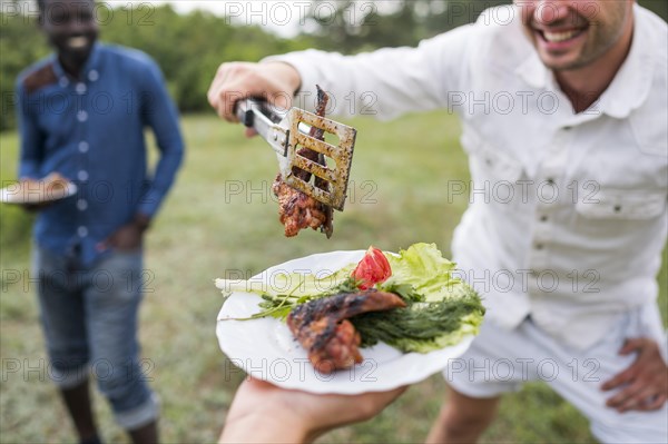 Men cooking barbecue outdoors