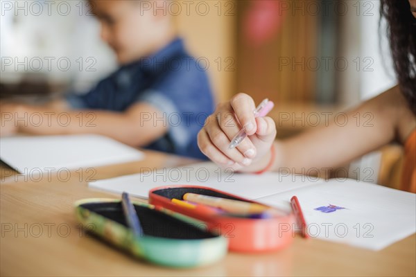 Schoolchildren sitting desk with notebooks