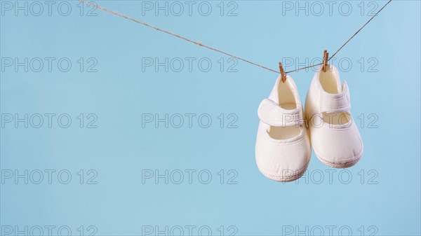 Front view cute little baby shoes with copy space