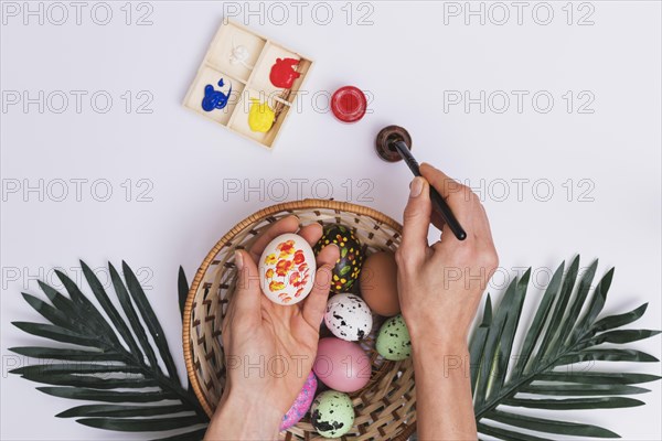 Crop hand painting eggs bowl