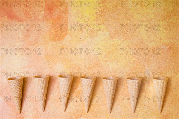 Waffle cones row multicolored background