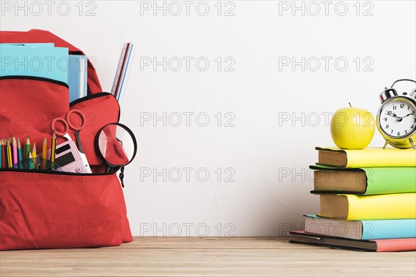 Alarm clock stack books well packed school backpack with supplies