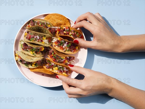 Woman with plate full tacos