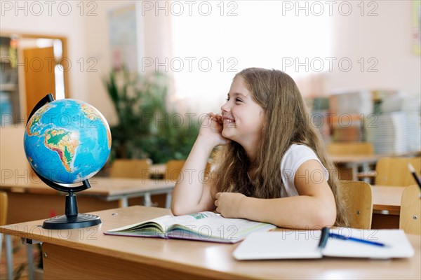 Schoolgirl smiling desk