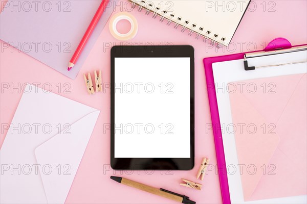 Top view tablet with pink stationery
