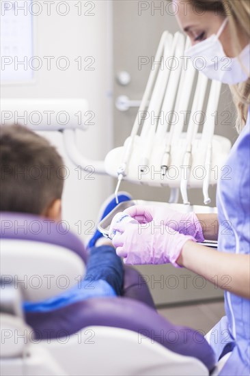 Female dentist looking teeth plaster mold clinic