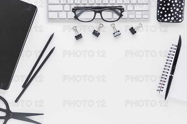 Workplace with stationery glasses keyboard