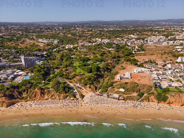 The waves of the Atlantic Ocean crash on Maria Luisa beach in the Portuguese Algarve in the district of Faro.