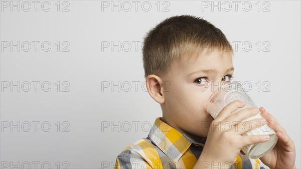 Boy drinking milk with glass