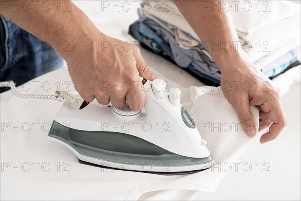 Man ironing clothes side view