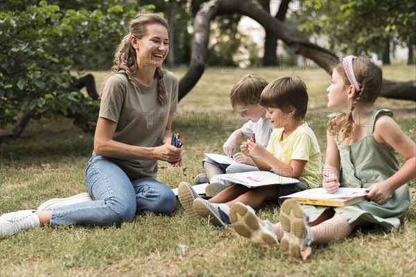 Smiley teacher kids outdoors