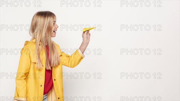 Side view girl with paper airplane