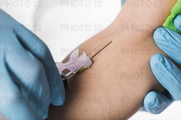 Close up doctor taking blood sample from sick person