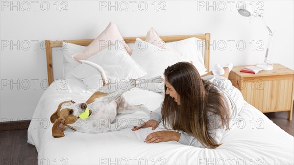 Full shot girl bed with dog