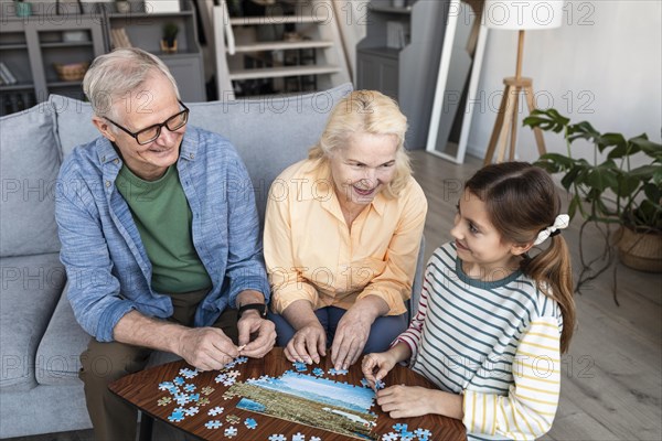 Grandparents girl doing puzzle medium shot