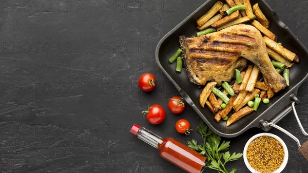 Top view baked chicken potatoes pan with tomatoes copy space