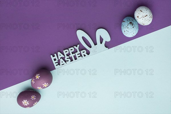 Top view colorful easter eggs with bunny ears greeting