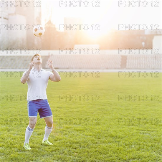 Young sportsman throwing ball