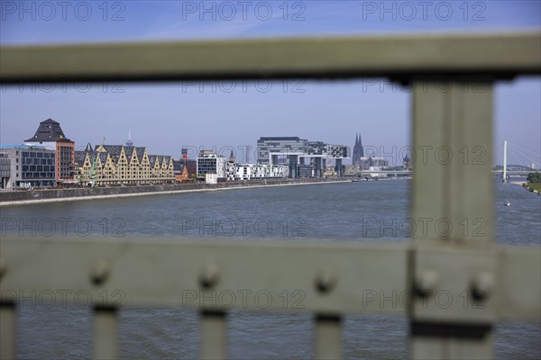 View of the city of Cologne and the Rhine through the railing of the South Bridge with Rheinauhafen