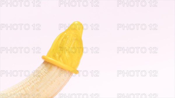 Yellow unwrapped condom banana