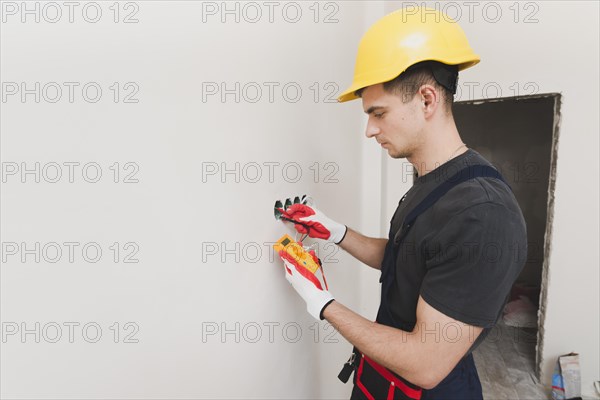 Electrician working with measure tool