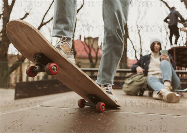 Man woman spending time together outdoors while skateboarding