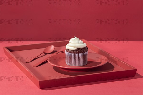 High angle cupcake with cream plate