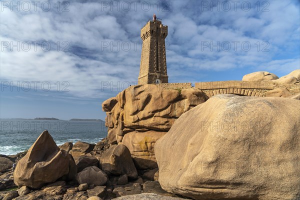 The rocks of the pink granite coast Cote de Granit Rose and the lighthouse Phare de Ploumanac'h near Ploumanac'h