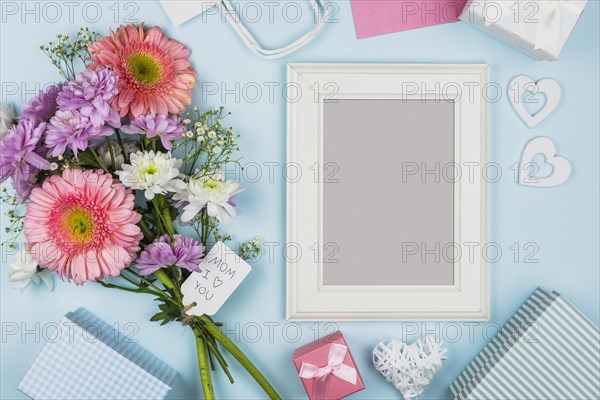 Frame near fresh flowers with title tag decorations