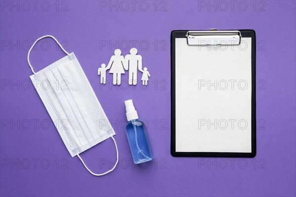 Top view family made paper with clipboard medical mask