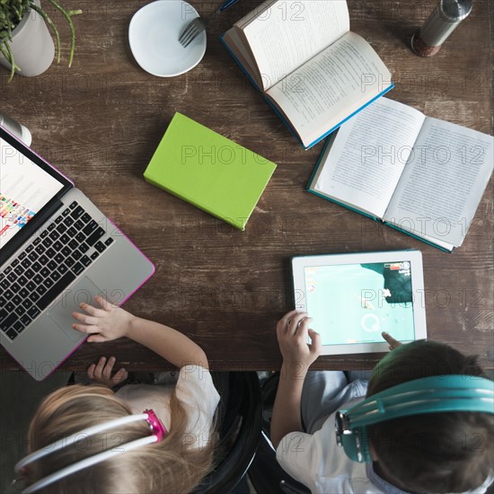 Top view kids with laptop tablet