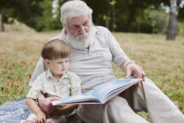 Grandpa grandson park reading