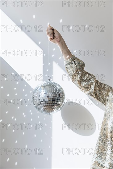 New year party concept with girl holding disco ball