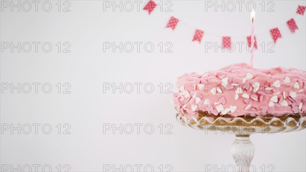 Pink cake decorated with candle