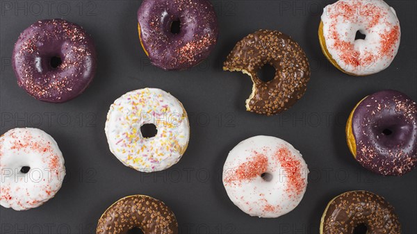 Set delicious sweet bitten donuts with colorful coating