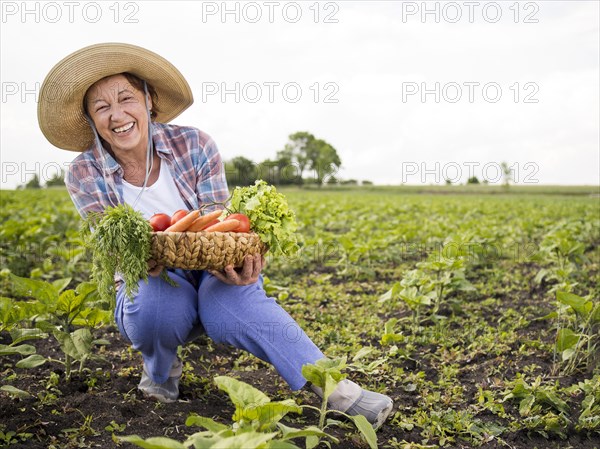 Woman holding basket full vegetables with copy space