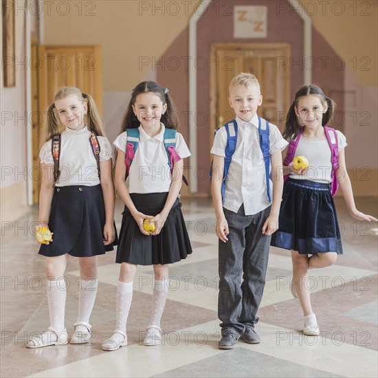 Cheerful pupils with apples