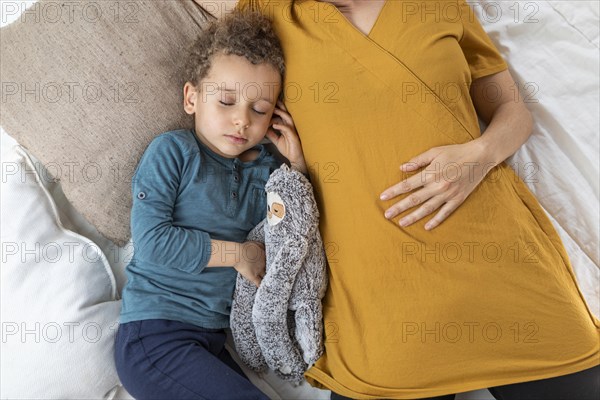 Little boy sleeping his mother