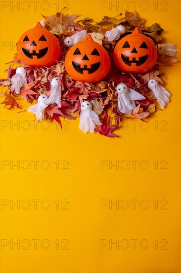 Overhead view of orange Halloween pumpkins on a background of yellow