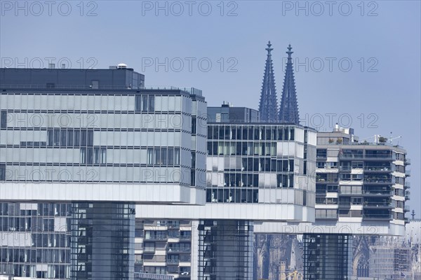 The 3 crane houses in Cologne's Rheinauhafen harbour in front of Cologne Cathedral